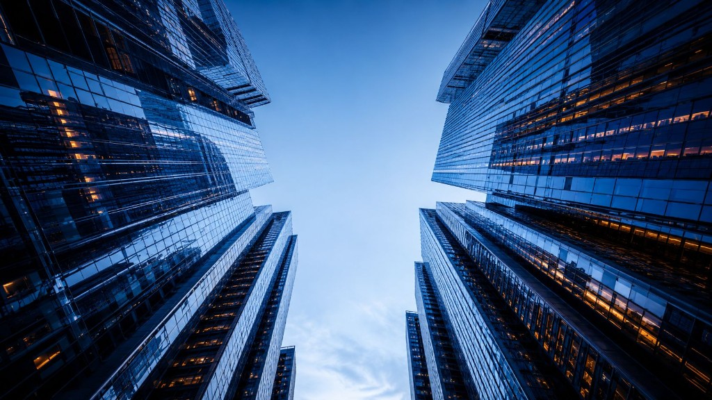 Modern glass skyscrapers viewed from below against a blue sky